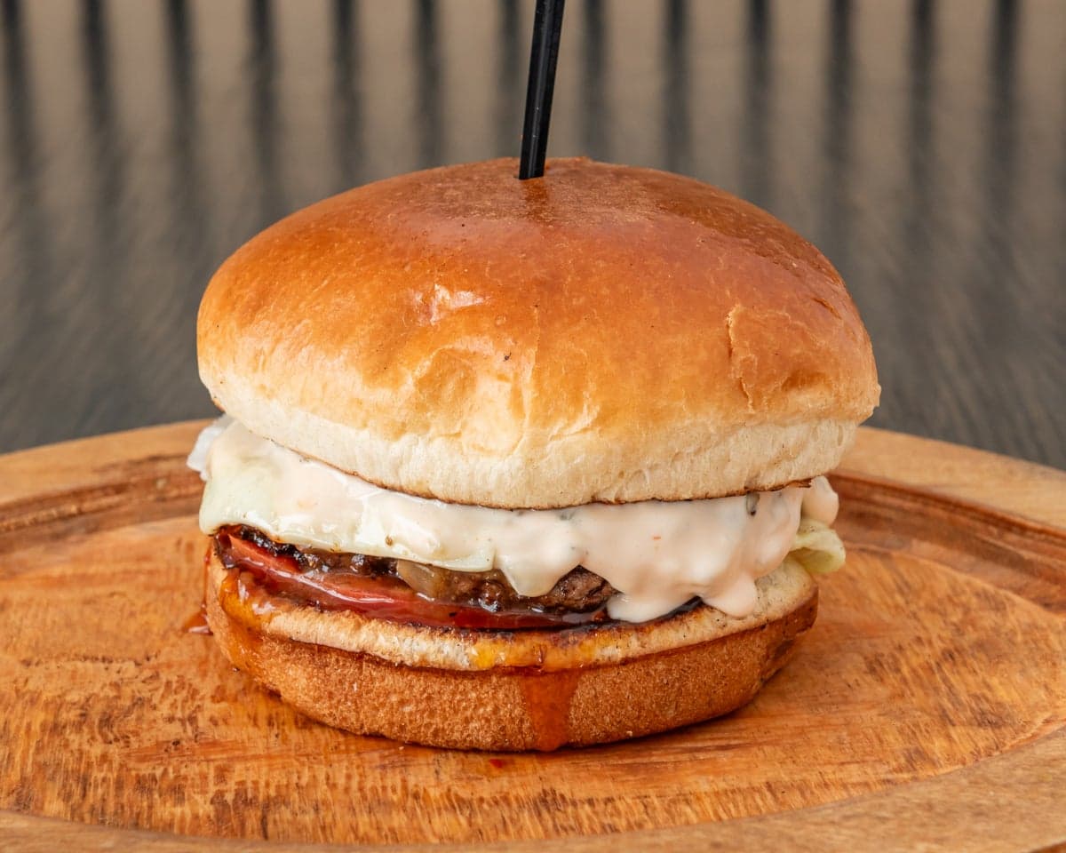 The Smile Burger — beef patty, sweet chili sauce, pickles, lettuce and American cheese